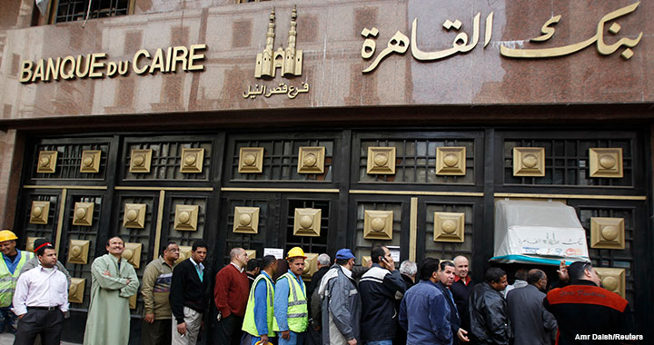 EGYPT People stand in line to make withdrawals outside Cairo Bank in downtown Cairo on 6 February 2011, the first day for the country’s banks to open after a weeklong closure due to political protests.