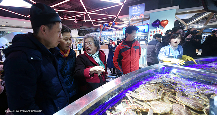 Customers select seafood at Hema, a store launched by Alibaba Group Holding Ltd, in Hangzhou, China.