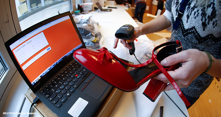 A fitting model enters data in a laptop after she checks out sizes for a shoe which goes on sale at the online shop of fashion retailer Zalando in Berlin, Germany, 17 December 2018.