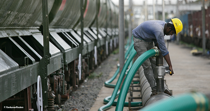 A technician checks a valve before water is pumped into a tanker train. The water will be supplied to the drought-hit city of Chennai in India.