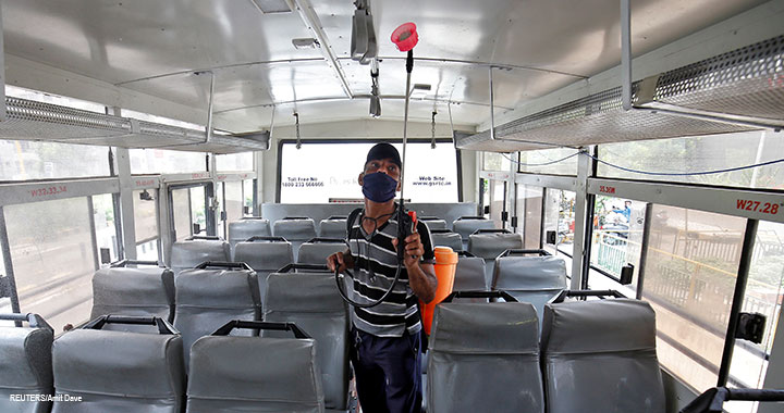 A man sprays disinfectant to sanitise a passenger bus to prevent the spread of the coronavirus disease (COVID-19), after authorities eased lockdown restrictions that were imposed to slow the spread of the disease, in Ahmedabad, India, 1 July 2020.