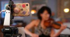With concert halls closed due to COVID-19, a phone on a tripod livestreams National Symphony Orchestra principal second violin Marissa Regni playing on NSO@Home LIVE from her home in Annandale, Virginia, in the US.