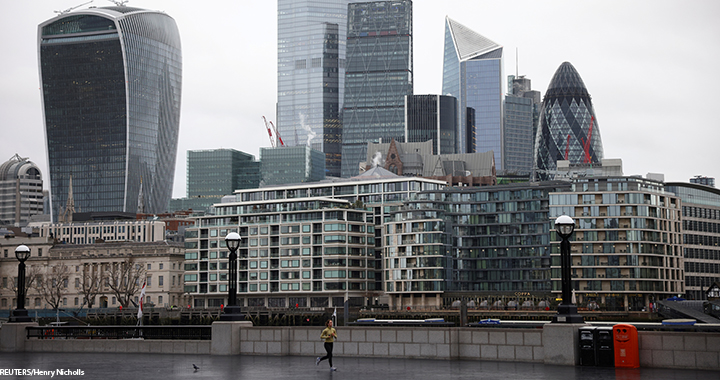 A person jogs, with financial district in the background, amid the coronavirus disease (COVID-19) outbreak, in London, UK, 5 January 2021.