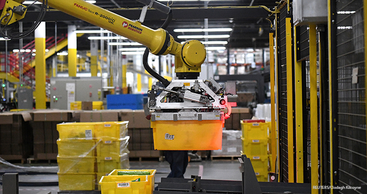 A six-axis robotic arm picks up sorting containers at the Amazon fulfillment center in Baltimore, Maryland.