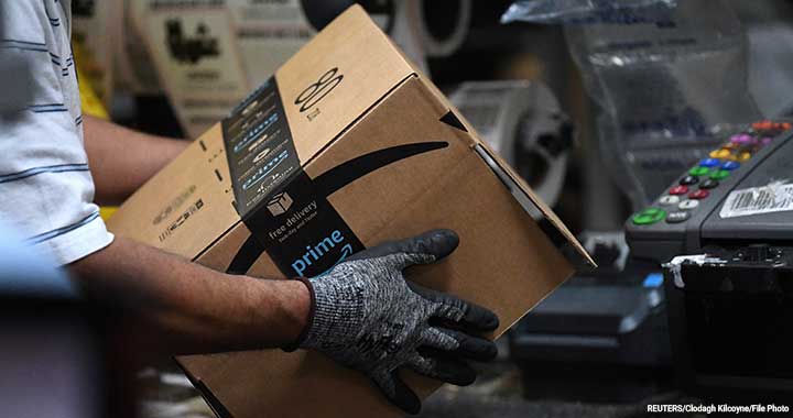 A worker assembles a box for delivery at the Amazon fulfillment center in Baltimore, Maryland, US, 30 April 2019.