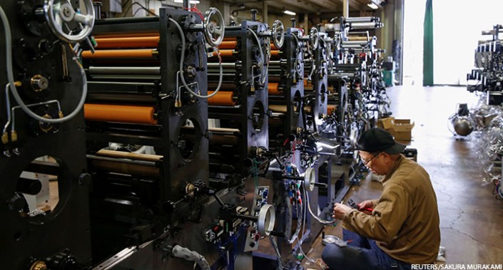 A worker checks machinery at a factory in Higashiosaka, Japan, 23 June 2022.