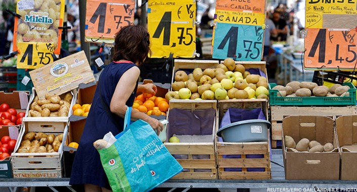 Price tags are seen as a woman shops at a local market in Nice, France, 7 June 2022.