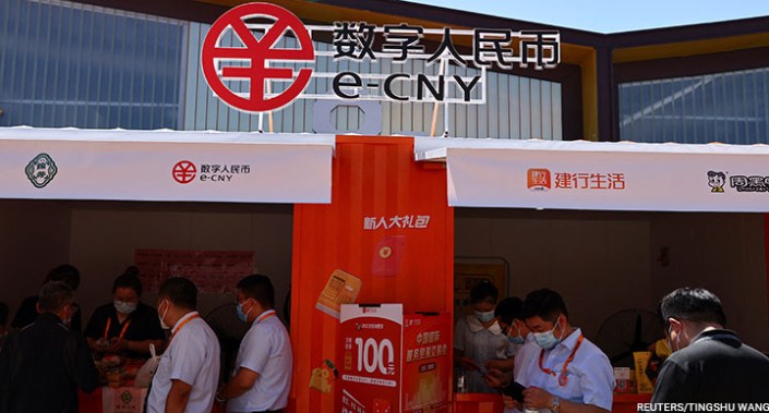 People buy food at stalls promoting China's digital yuan, or e-CNY, during the 2022 China International Fair for Trade in Services (CIFTIS) in Beijing, China, 1 September 2022.