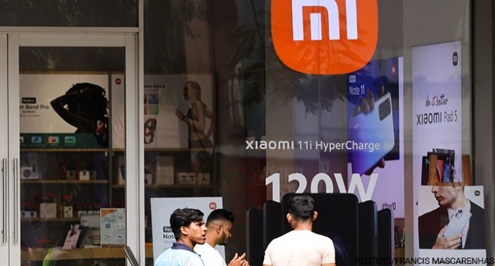 People walk past a Xiaomi store in Mumbai, India, 11 May 2022. Xiaomi is a Chinese manufacturer of consumer electronics.