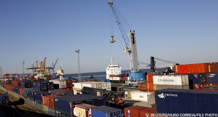Workers unload containers at the Port of Lisbon, Portugal, 22 May 2015.