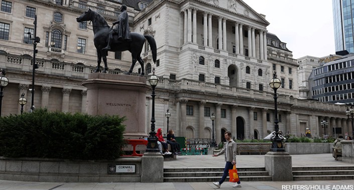 A pedestrian carries a shopping bag while walking past the Bank of England in London earlier this summer.