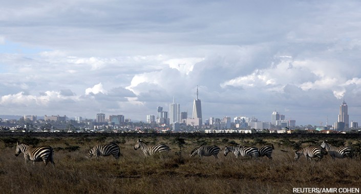 The Nairobi skyline is seen in the background as zebras walk through the Nairobi National Park near Nairobi, Kenya, 3 December 2018.