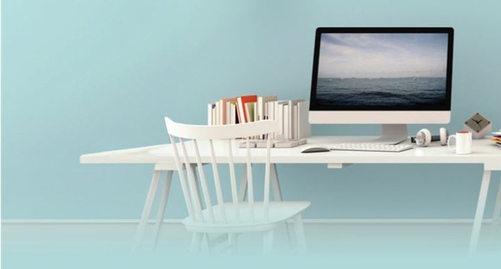 Image of books and computer monitor on a desk. PHOTO BY SRIJAROEN/ADOBE STOCK