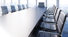Photo of desk with executive chair at the head.