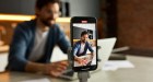 Man recording cell phone video of himself at computer.